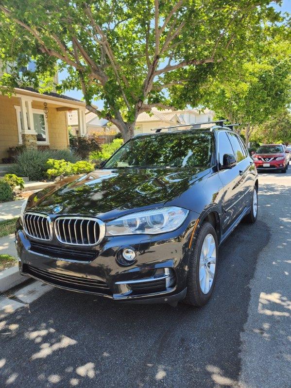 Black BMW X5 with a mirror finish after paint correction