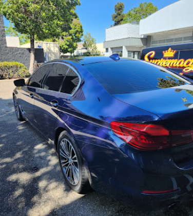 Deep blue BMW coupe with mirror-like reflections after polishing