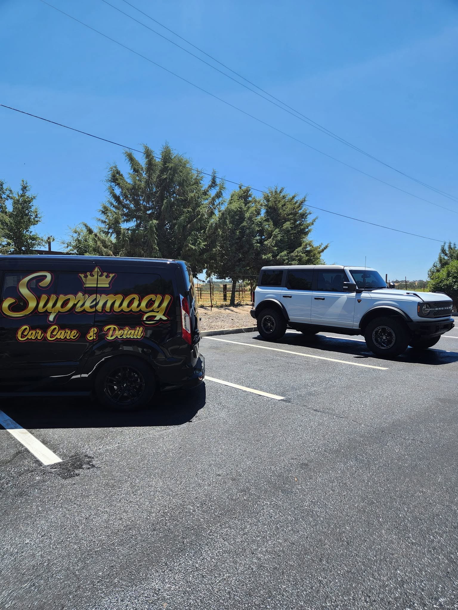 Supremacy Car Care mobile detailing van parked on a job site