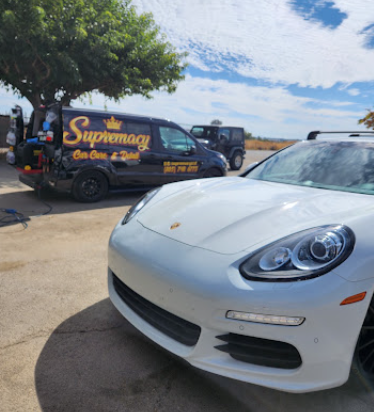 White Porsche Panamera detailed beside the Supremacy mobile unit