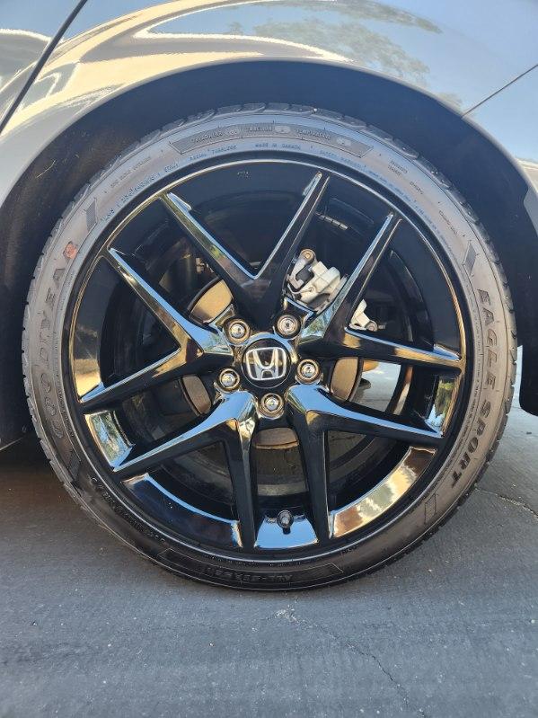 Close-up of a cleaned Honda alloy wheel and tire dressing
